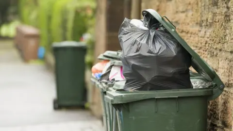 Getty Images Full wheelie bin