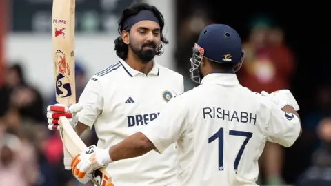 India opener KL Rahul (left) embraces team-mate Rishabh Pant (right) after hitting a century