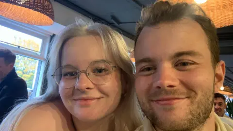 Family handout A close up shot of Ella and Jack looking at the camera. Ella has long straight blonde hair and wears glasses.
