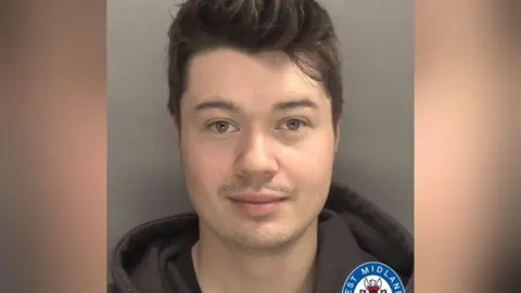 West Midlands Police A mugshot of a man with short brown hair, wearing a black hoody