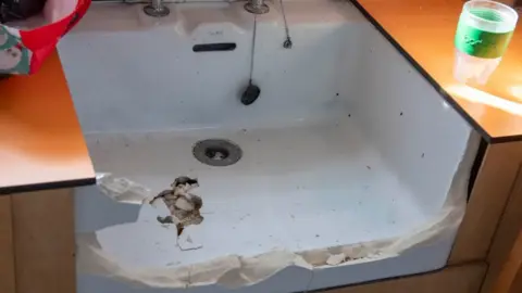 City of Wolverhampton Council A sink has been smashed with piece of concrete missing and damage in the inside.