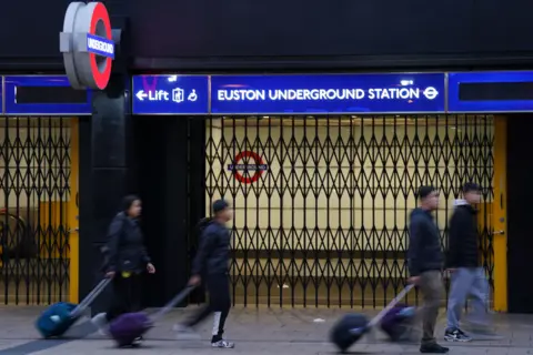 PA Media Barriers are drawn across the entrance to Euston Underground station