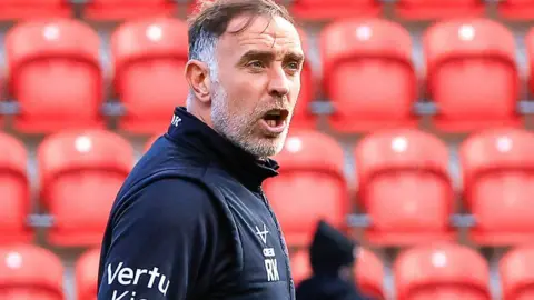Richard Keogh puts out cones before a Barnsley match