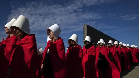 AFP Activists dressed as handmaids