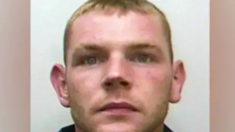 merseyside police Mugshot of Stephen. He has short blonde hair and large ears.