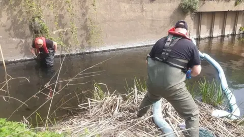 Environment Agency Boom being placed in River Derwent