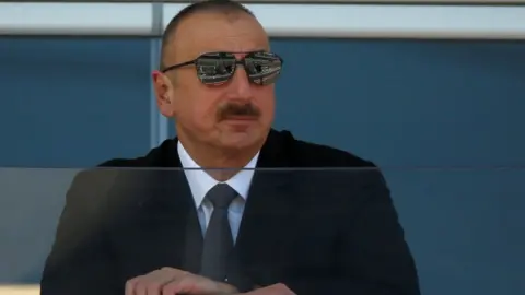 Reuters Azerbaijan's President Ilham Aliyev watches a parade in Baku on 25 June