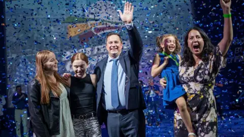 AFP South African main opposition party Democratic Alliance (DA) newly elected federal leader John Steenhuisen rejoices with his family on the stage of the party's Federal Congress in Midrand, Johannesburg on April 2, 2023.