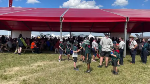 People at RIAT under a large red marquee