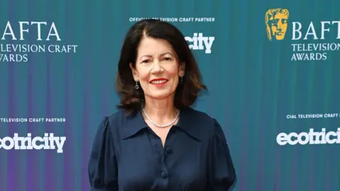Getty Images Pippa Harris smiling towards the camera at the BAFTA awards