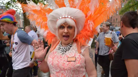 Getty Images Man in drag costume waves