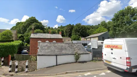 Sunny village road with local shops exterior