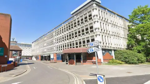 A street view of a large carparking complex in a town centre.