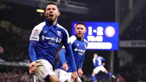 John Walton/PA Media Conor Chaplin celebrates scoring a goal for Ipswich Town at Portman Road