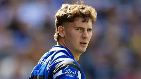 Ciaran Donoghue in the blue, black and white shirt of Bath