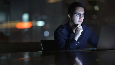 Businessman looking at laptop