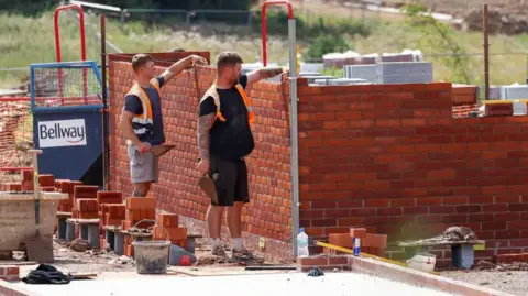 Getty Images Bricklayers building a house