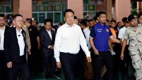 EPA Thai Prime Minister Anutin Charnvirakul, wearing a white, visits the school