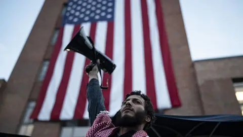 Getty Images A student hold a megaphone up as he takes part in a pro-Palestinian demonstration at George Washington University in Washington DC