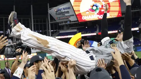 Reuters Shohei Ohtani is lifted up by his teammates in celebration after the game