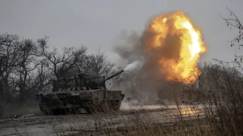 Getty Images Ukrainian soldiers fire at Russian targets near Avdiivka