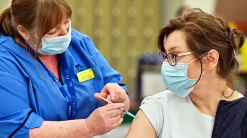 Getty Images Woman being vaccinated in Glasgow