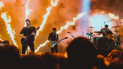 Elliott Ingham Ben on stage with Fall Out Boy