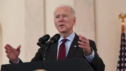 AFP via Getty Images US President Joe Biden speaks about lives lost to Covid after death toll passed 500,000, in the Cross Hall of the White House in Washington, DC, February 22, 2021.