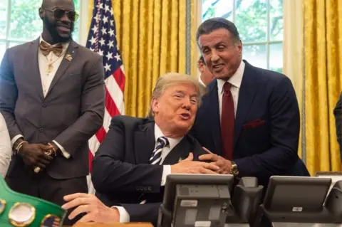 Getty Images Actor Sylvester Stallone (right) and boxer Deontay Wilder (left) were present for the pardon signing.