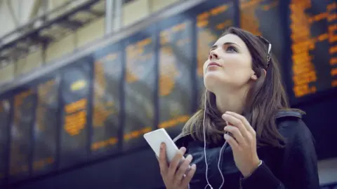 Getty Images Woman at train station