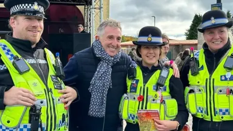 Jules Gardner Former rugby union and league player Jonathan Davies with police officers at the unveiling of the statue