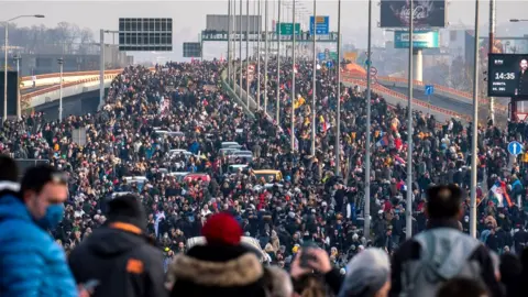 Getty Images Demonstrators block a highway to protest against Anglo-Australian company Rio Tinto's plan to mine lithium in the country, in Belgrade, 4 December 2021