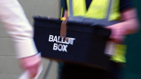 A ballot box being carried in to a count