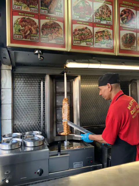 Ahmed Khan preparing kebabs in his shop