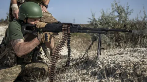 Getty Images A Ukrainian fires a machine gun