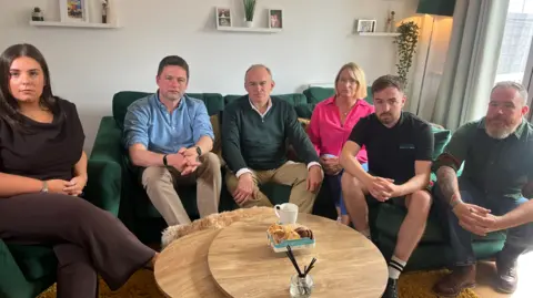 Sir Ed Davey with five people - two women and three men. 