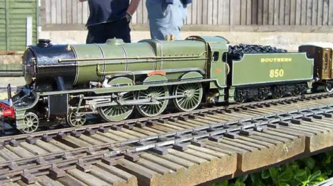 Romney Marsh Model Engineering Society One of the model railways at the Romney Marsh Model Engineering Society. The green model can be seen on the track.