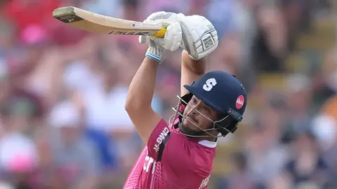 Nathan McSweeney lofts the ball away during an innings for Northamptonshire