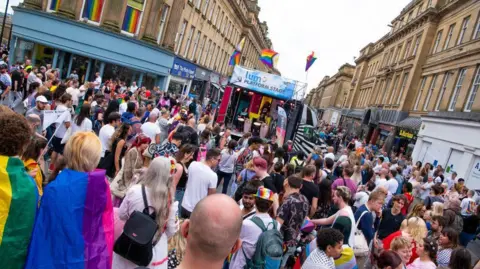 Newcastle City Council Festival-goers look on as musicians play on a small stage near Grey's Monument in Newcastle city centre.