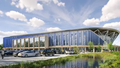 Oxford United CGI Image de l'extérieur du nouveau stade prévu d'Oxford United avec des voitures garées à l'extérieur et un étang et une zone verte sur le côté