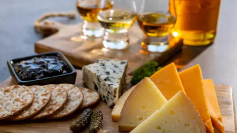 Getty Images A tray of cheese with pickles, biscuits and whisky