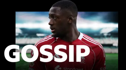 Head-and-shoulders image of Ibrahima Konate. He has short black hair and a goatee beard. He is wearing Liverpool's red home shirt. The word "Gossip" is imposed over the photograph.