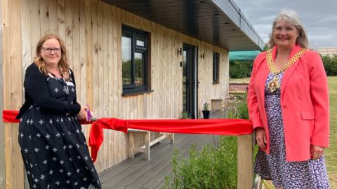 Rebecca Smith and Mayor of Gloucester Lorraine Campbell cut the ribbon on new wellbeing cabin