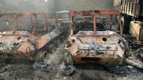 CBS Close-up of burnt-out cars in a car park