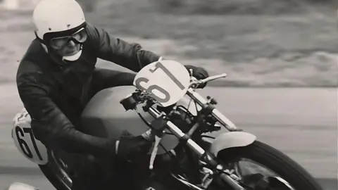 Gordon Castle A black and white image of a man on a motorbike obviously racing with the number 67 on his bike at the front and at the back. 