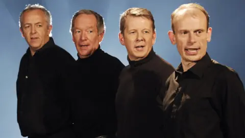 Newsreaders Jeremy Bowen, Michael Buerk, Bill Turnbull and Andrew Marr performing Bohemian Rhapsody for Children in Need in 2005