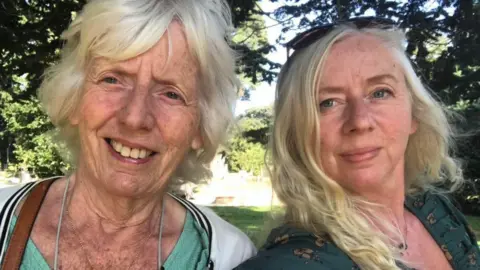 Dawn Booth Dawn Booth and her mother Mavis Cooper. The pair are posing for a selfie. They both have fair hair. 