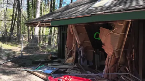 The damaged toilet block with metal fencing erected around it.