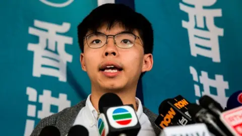 Getty Images Pro-democracy activist Joshua Wong speaks to the media in front of the high court in Hong Kong on May 16, 2019, before judgement is handed down on his appeal of a three-month jail term received for contempt of court during the clearance of Mong Kok at the 2014 occupy protests.