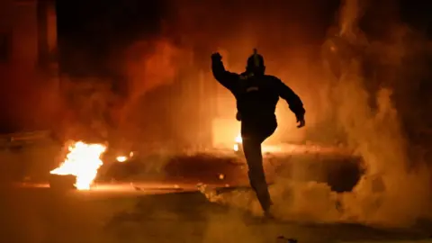 Reuters A demonstrator kicks a tear gas canister